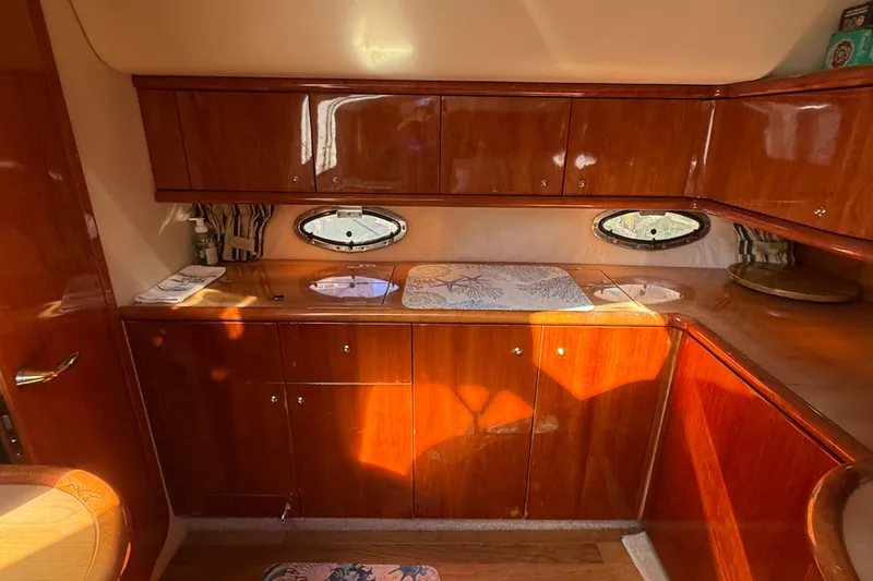 Slide: The Image of Luxurious wooden interior of 2002 Sunseeker Camargue 44 yacht kitchen area. - 9