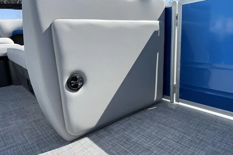 Slide: The Image of 2026 Sun Tracker Party Barge 20 DLX interior with gray seating and blue paneling. - 12