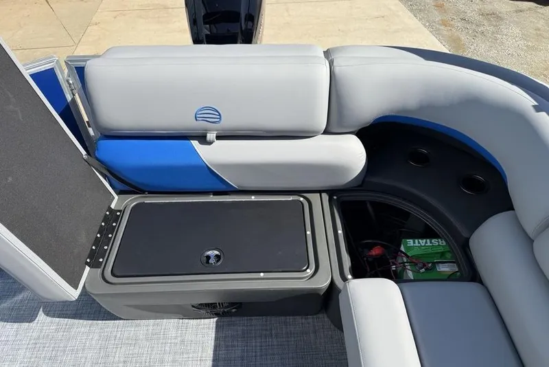 Slide: The Image of 2026 Sun Tracker Party Barge 20 DLX interior seating with storage compartment open. - 28