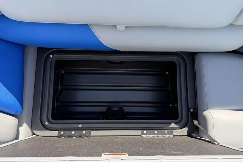 Slide: The Image of 2026 Sun Tracker Party Barge 20 DLX storage compartment with blue and gray seating. - 3