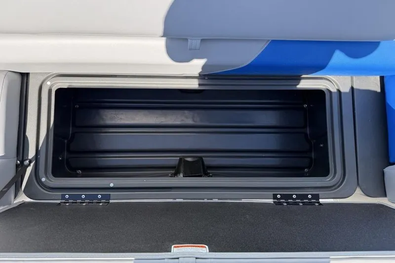 Slide: The Image of 2026 Sun Tracker Party Barge 20 DLX storage compartment, open and empty. - 7