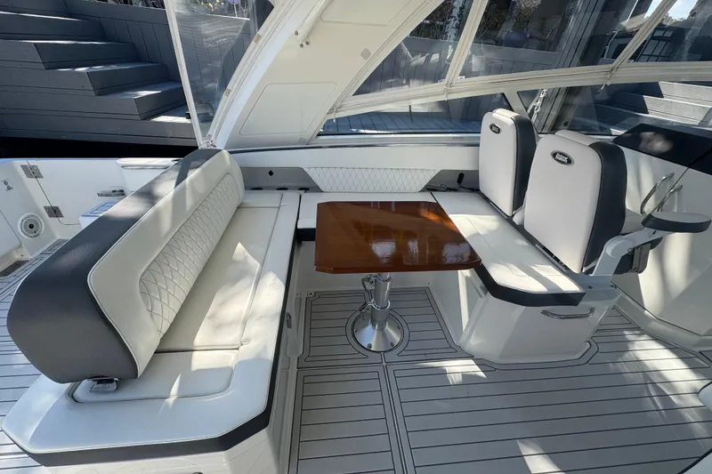Slide: The Image of Luxurious seating area on 2021 World Cat 400 DC-X boat with elegant table. - 10