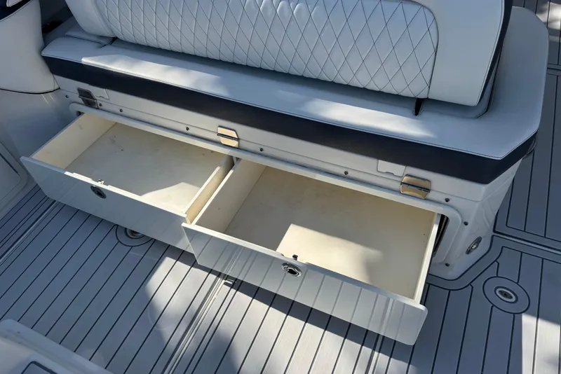 Slide: The Image of World Cat 400 DC-X 2021 boat interior with open storage drawers and cushioned seating. - 13