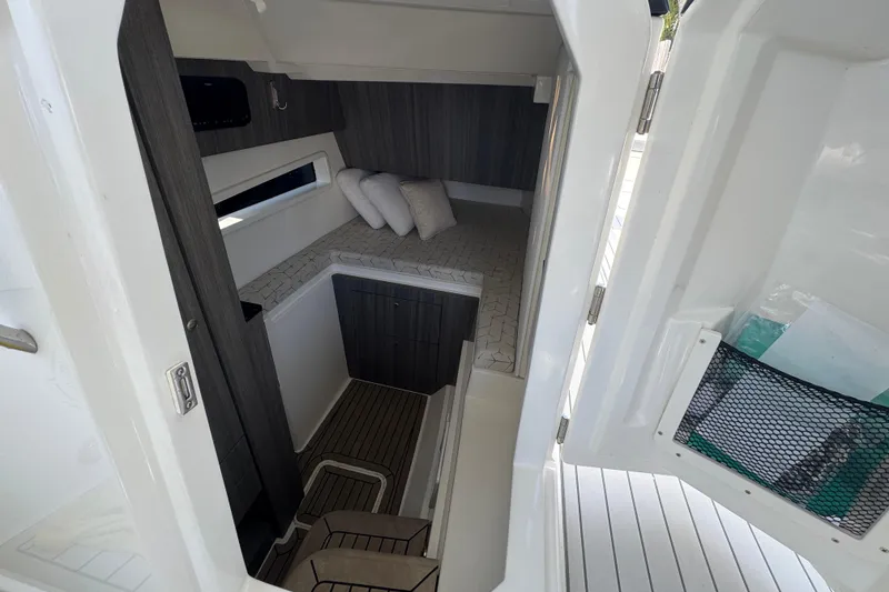 Slide: The Image of Interior cabin of 2021 World Cat 400 DC-X boat, featuring cozy bedding and modern design. - 18