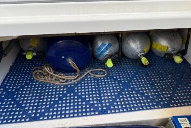 Slide: The Image of Storage compartment with scuba tanks and rope on a World Cat 400 DC-X boat, 2021 model. - 19