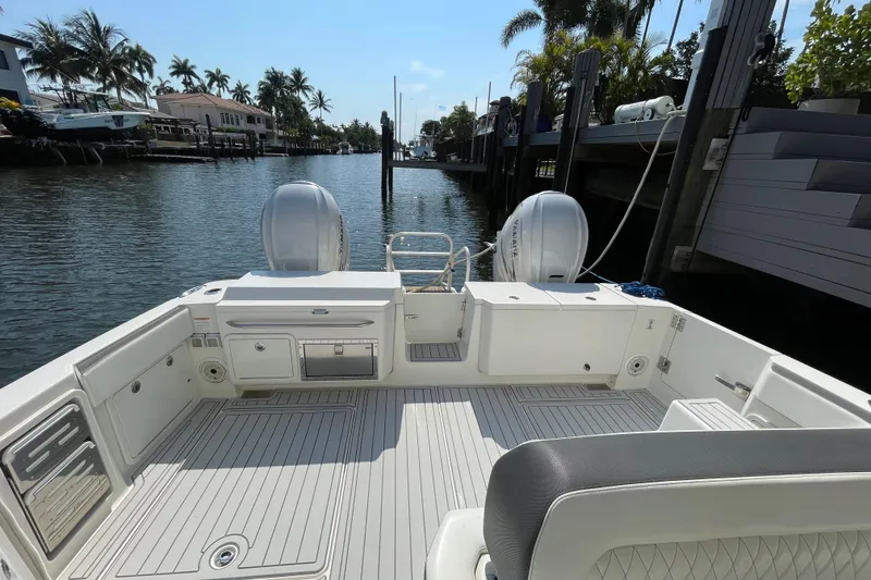Slide: The Image of World Cat 400 DC-X 2021 boat deck with dual engines, docked in a scenic canal. - 22