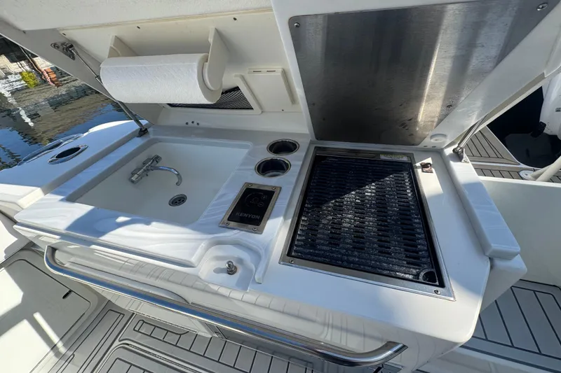 Slide: The Image of Outdoor kitchen on 2021 World Cat 400 DC-X boat with sink and grill. - 23