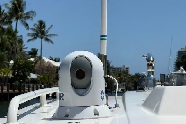 Slide: The Image of 2021 World Cat 400 DC-X boat with radar equipment, palm trees in the background. - 25