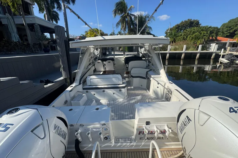 Slide: The Image of 2021 World Cat 400 DC-X boat docked, featuring spacious seating and twin Yamaha engines. - 28