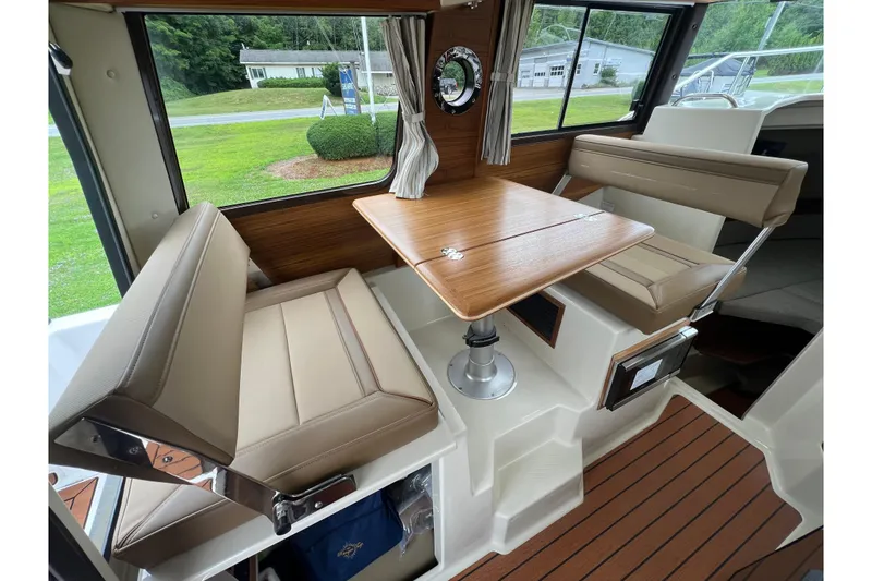 Slide: The Image of Interior of 2025 Ranger Tugs R-25 with seating and wooden table. - 14