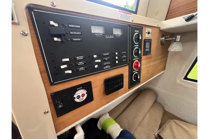 Slide: The Image of Control panel of 2025 Ranger Tugs R-25 boat with switches and gauges. - 16