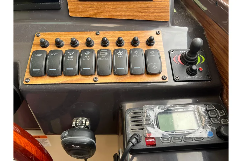 Slide: The Image of Control panel of 2025 Ranger Tugs R-25 boat with switches and thruster joystick. - 19