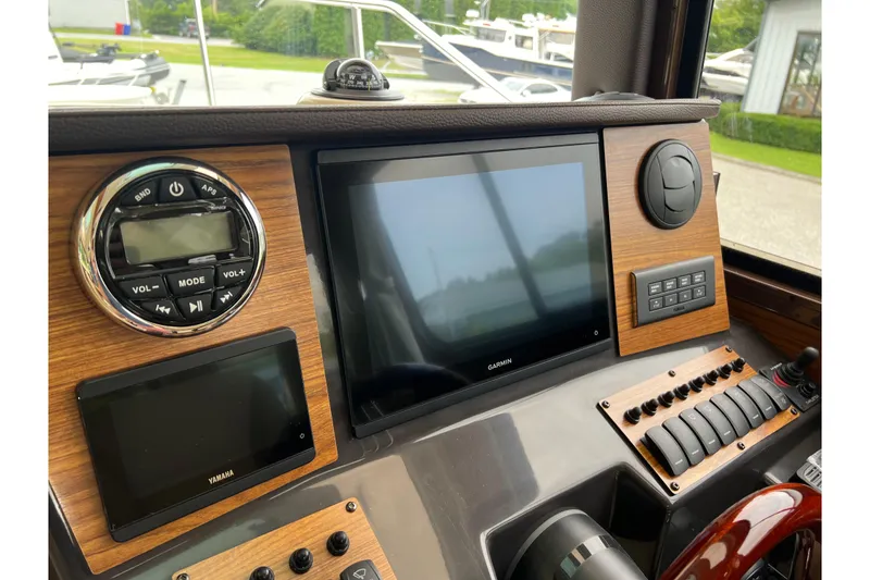 Slide: The Image of 2025 Ranger Tugs R-25 dashboard with Garmin display and Yamaha controls. - 21
