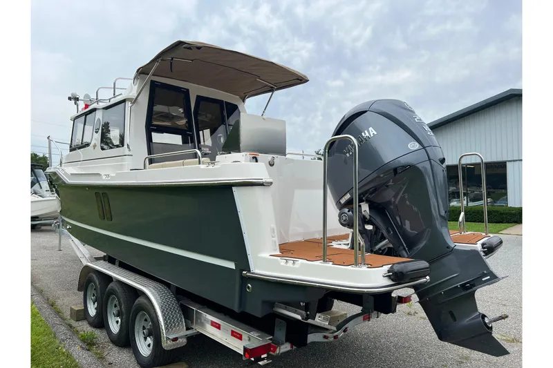 Slide: The Image of 2025 Ranger Tugs R-25 boat on trailer with Yamaha outboard motor. - 3