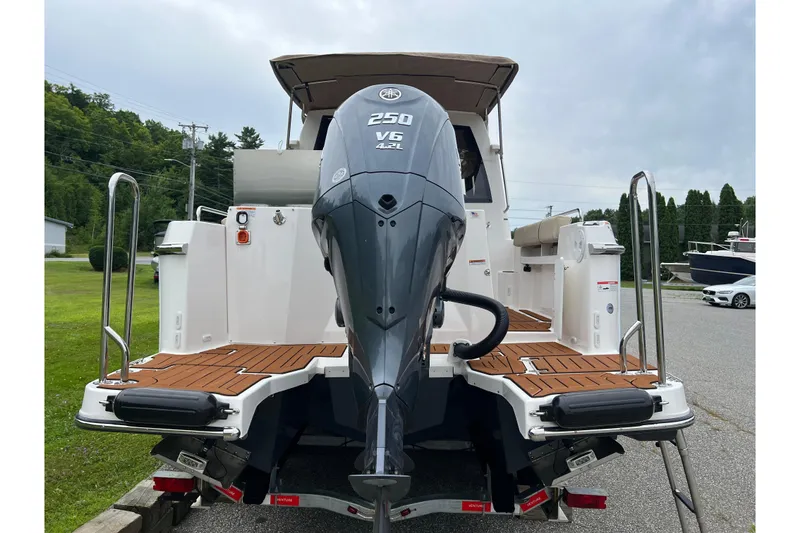 Slide: The Image of 2025 Ranger Tugs R-25 boat with Yamaha 250 V6 engine, docked outdoors. - 5