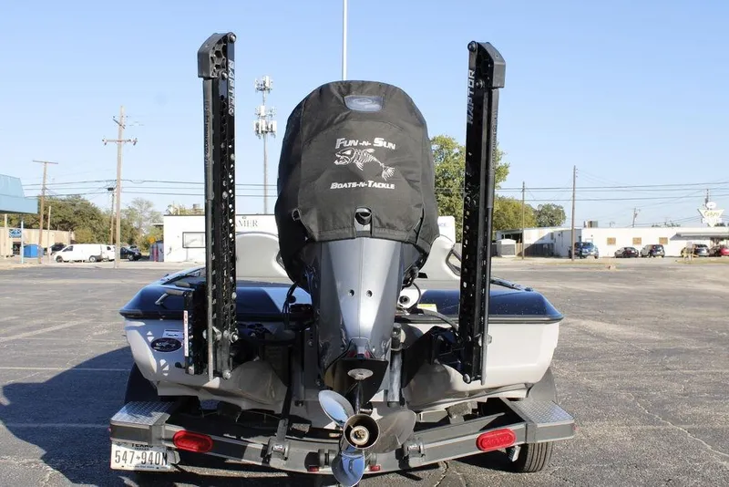 Slide: The Image of 2023 Skeeter ZXR21 boat with motor cover, parked on a trailer in a lot. - 12