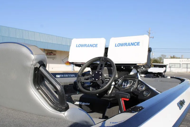 Slide: The Image of 2023 Skeeter ZXR21 boat interior with dual Lowrance displays and steering wheel. - 14
