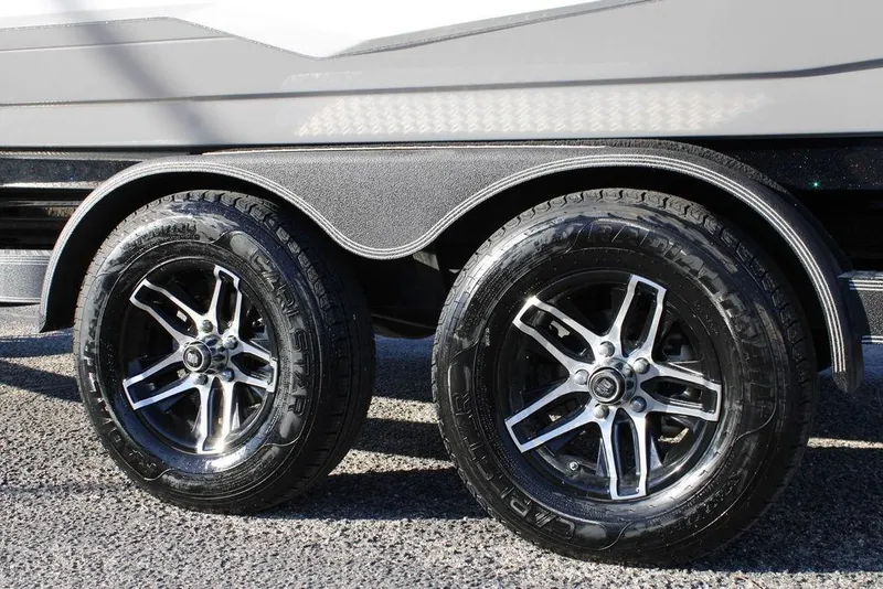 Slide: The Image of 2023 Skeeter ZXR21 trailer wheels with sleek black and silver rims. - 15