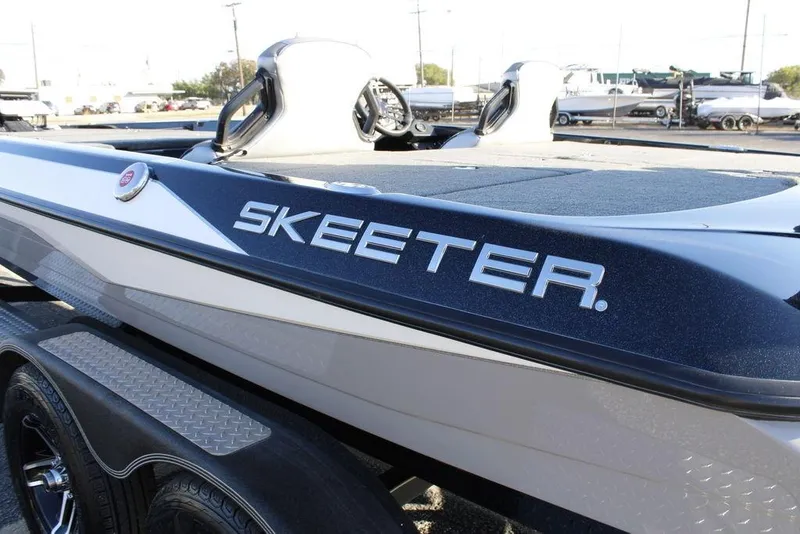 Slide: The Image of 2023 Skeeter ZXR21 boat, sleek design, parked on trailer, side view. - 21