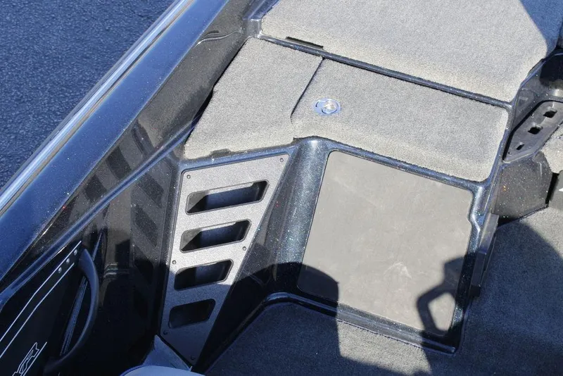 Slide: The Image of 2023 Skeeter ZXR21 boat interior with carpeted flooring and storage compartment. - 23