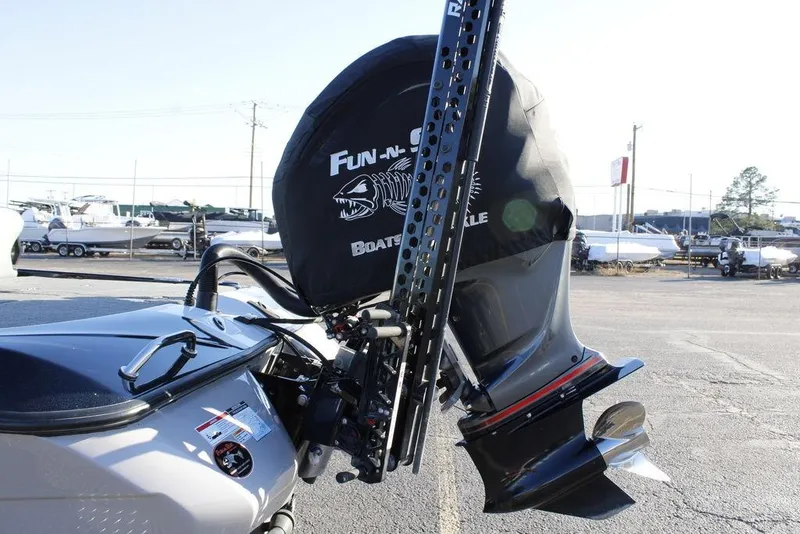 Slide: The Image of 2023 Skeeter ZXR21 boat motor with cover in a marina setting. - 26