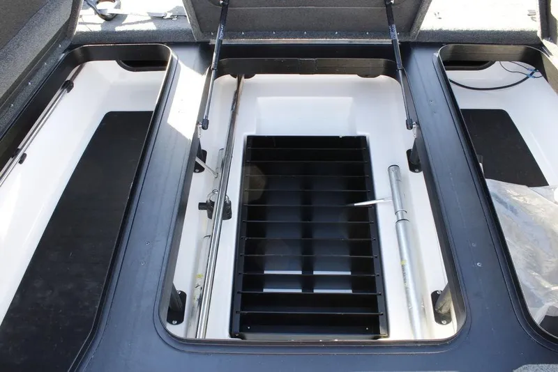 Slide: The Image of 2023 Skeeter ZXR21 boat storage compartments with open lids and organized interior. - 3