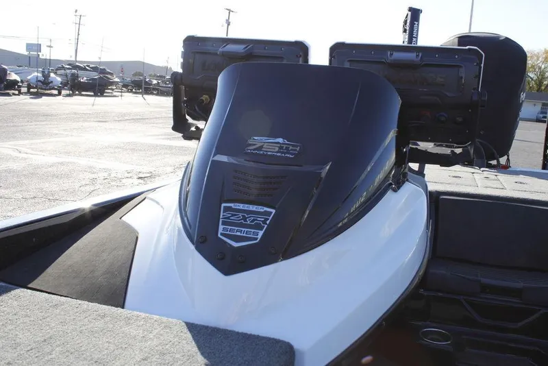 Slide: The Image of 2023 Skeeter ZXR21 boat with advanced dashboard and sleek design in a parking lot. - 30