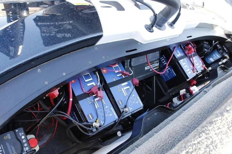 Slide: The Image of 2023 Skeeter ZXR21 boat battery compartment with multiple batteries and wiring. - 5
