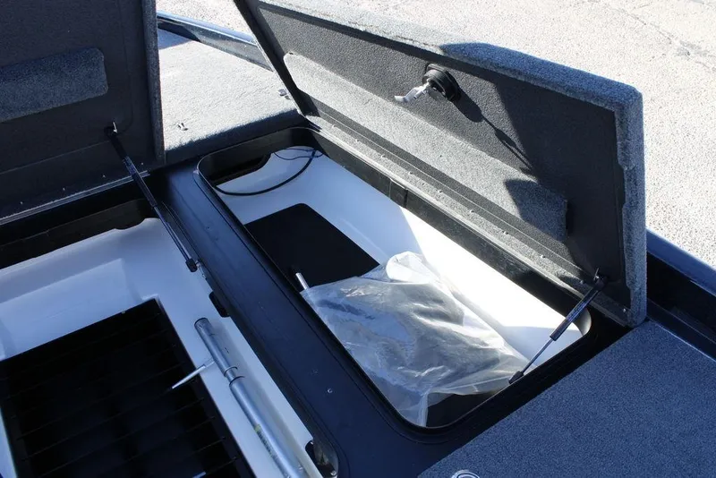 Slide: The Image of 2023 Skeeter ZXR21 boat storage compartment with open lid and visible interior. - 7
