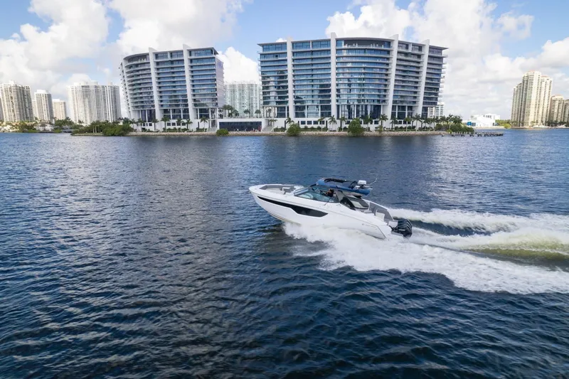 Slide: The Image of 2022 New Cruiser Yachts GLS 38 on water, city skyline in background. - 7