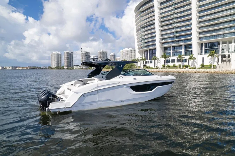 Slide: The Image of 2022 New Cruiser Yachts GLS 38 on water with city skyline backdrop. - 5