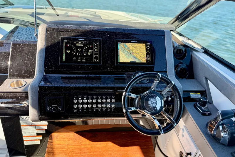 Slide: The Image of Cockpit of 2022 New Cruiser Yachts GLS 38 with navigation displays and steering wheel. - 22