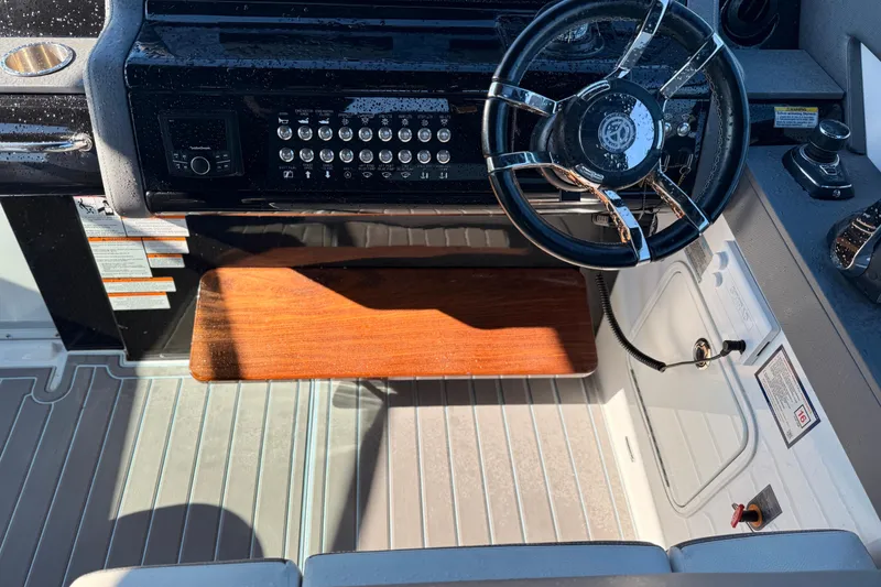 Slide: The Image of 2022 New Cruiser Yachts GLS 38 helm with steering wheel and control panel. - 23