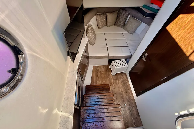 Slide: The Image of Interior of 2022 New Cruiser Yachts GLS 38, featuring cozy seating and modern amenities. - 28