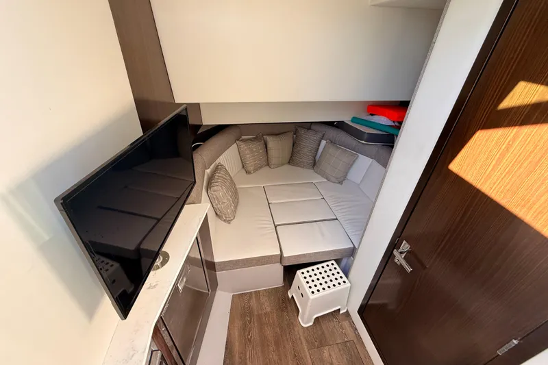 Slide: The Image of Interior of 2022 New Cruiser Yachts GLS 38, featuring cozy seating and a TV. - 29