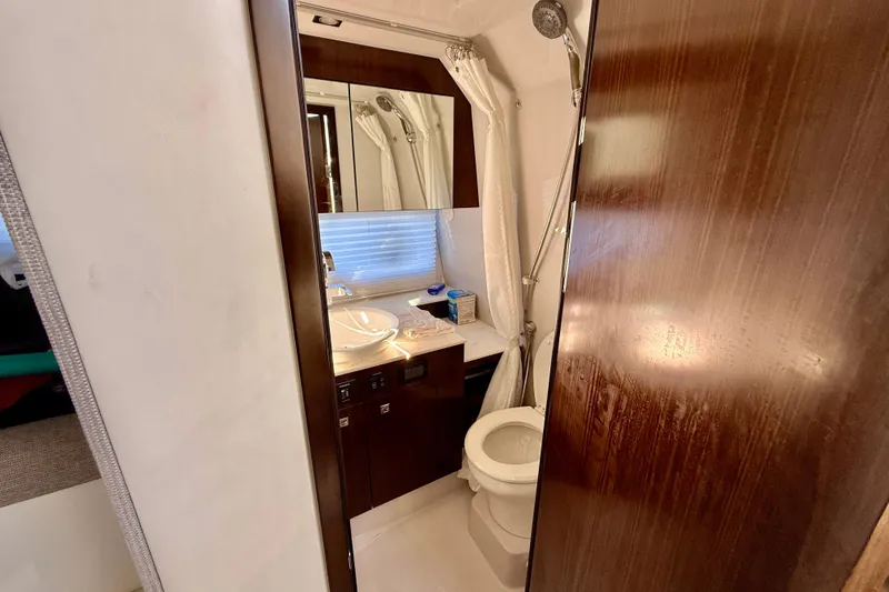 Slide: The Image of Luxurious bathroom in 2022 New Cruiser Yachts GLS 38, featuring modern fixtures and elegant wood finishes. - 36
