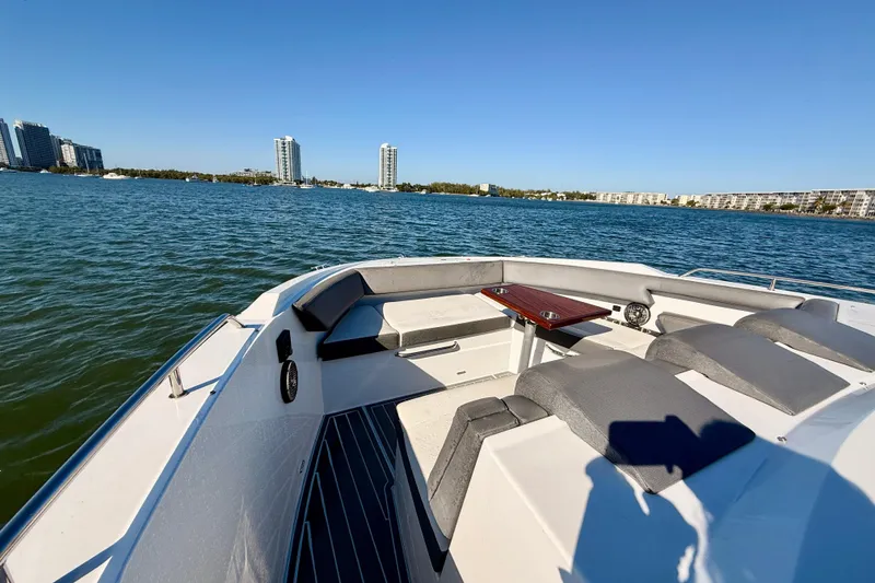 Slide: The Image of 2022 New Cruiser Yachts GLS 38 on water, featuring spacious deck seating and scenic city skyline. - 46