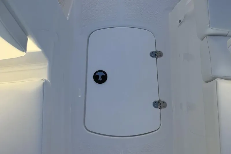 Slide: The Image of 2026 Tahoe T16 boat storage compartment with white interior and secure latch. - 12