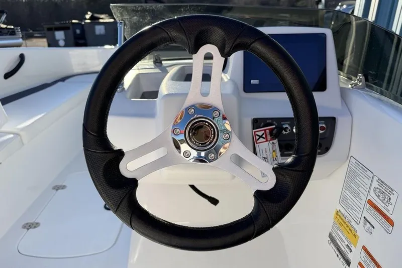 Slide: The Image of Steering wheel of 2026 Tahoe T16 boat with dashboard controls and display. - 13