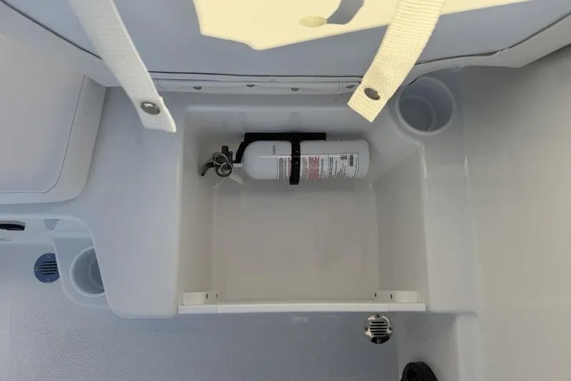 Slide: The Image of Storage compartment with fire extinguisher in 2026 Tahoe T16 boat. - 22