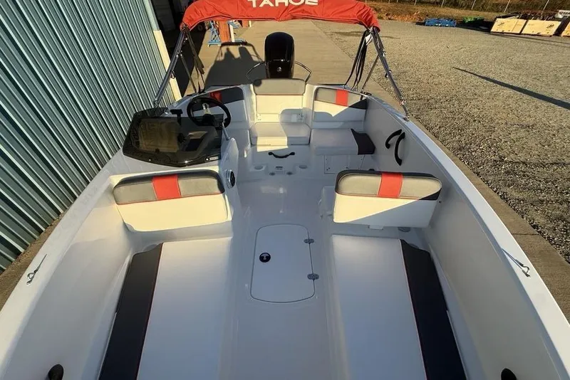 Slide: The Image of 2026 Tahoe T16 boat interior with red accents and seating, docked outdoors. - 29