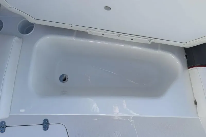 Slide: The Image of 2026 Tahoe T16 boat interior storage compartment with drain plug. - 4