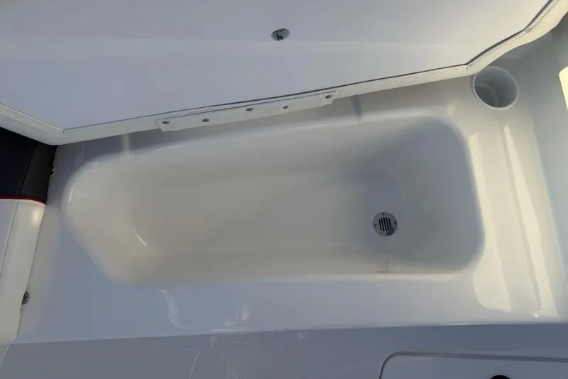 Slide: The Image of 2026 Tahoe T16 boat storage compartment with drain, open lid view. - 7