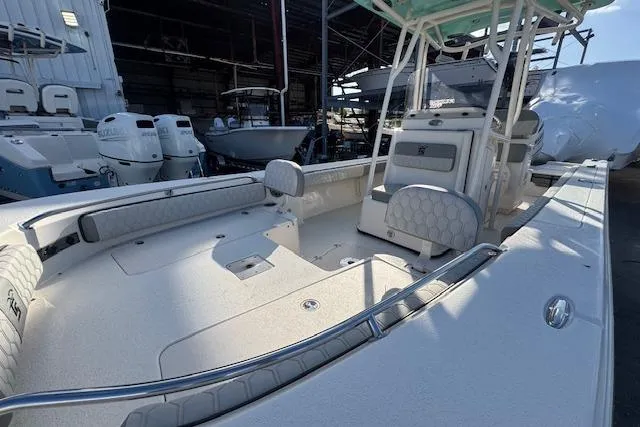 Slide: The Image of 2024 Carolina Skiff 24 Ultra Elite boat interior with seating and storage. - 11