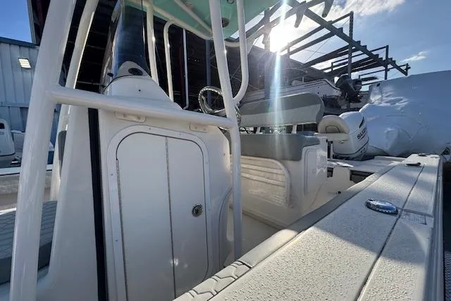 Slide: The Image of 2024 Carolina Skiff 24 Ultra Elite boat interior with seating and console, sunlit background. - 12