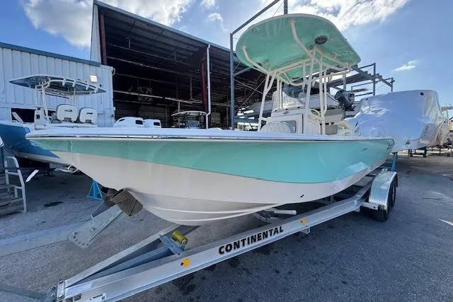 Slide: The Image of 2024 Carolina Skiff 24 Ultra Elite boat on trailer, dockside view. - 4