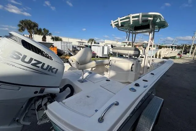 Slide: The Image of 2024 Carolina Skiff 24 Ultra Elite boat with Suzuki engine, docked outdoors. - 6