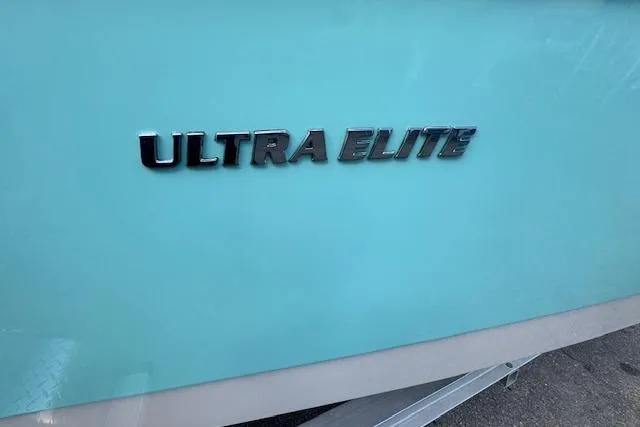 Slide: The Image of 2024 Carolina Skiff 24 Ultra Elite boat with turquoise hull and chrome lettering. - 8