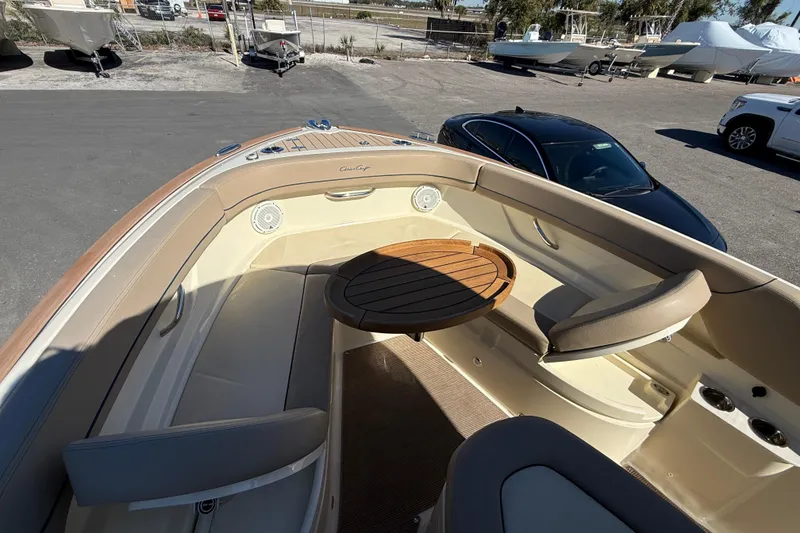 Slide: The Image of 2023 Chris-Craft Catalina 24 boat interior with seating and wooden table. - 16