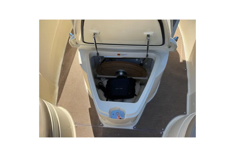 Slide: The Image of 2023 Chris-Craft Catalina 24 storage compartment with open hatch, showcasing interior details. - 18